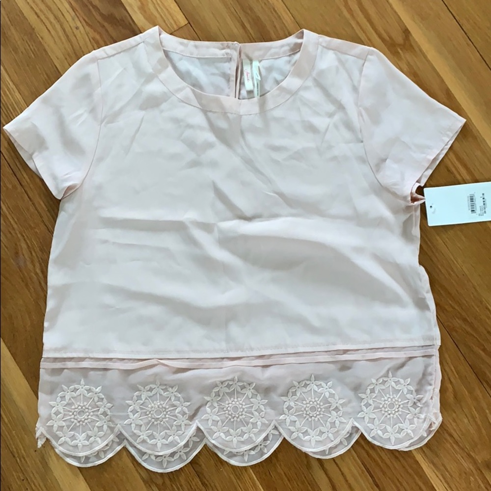 NWT. Light pink shirt with detailed bottom. Size S